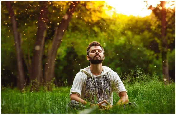man practicing a meditation in nature