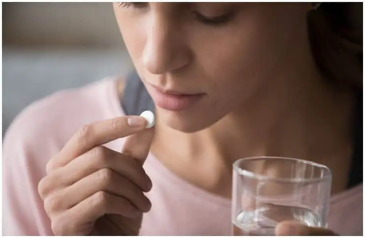 woman taking a drug pill